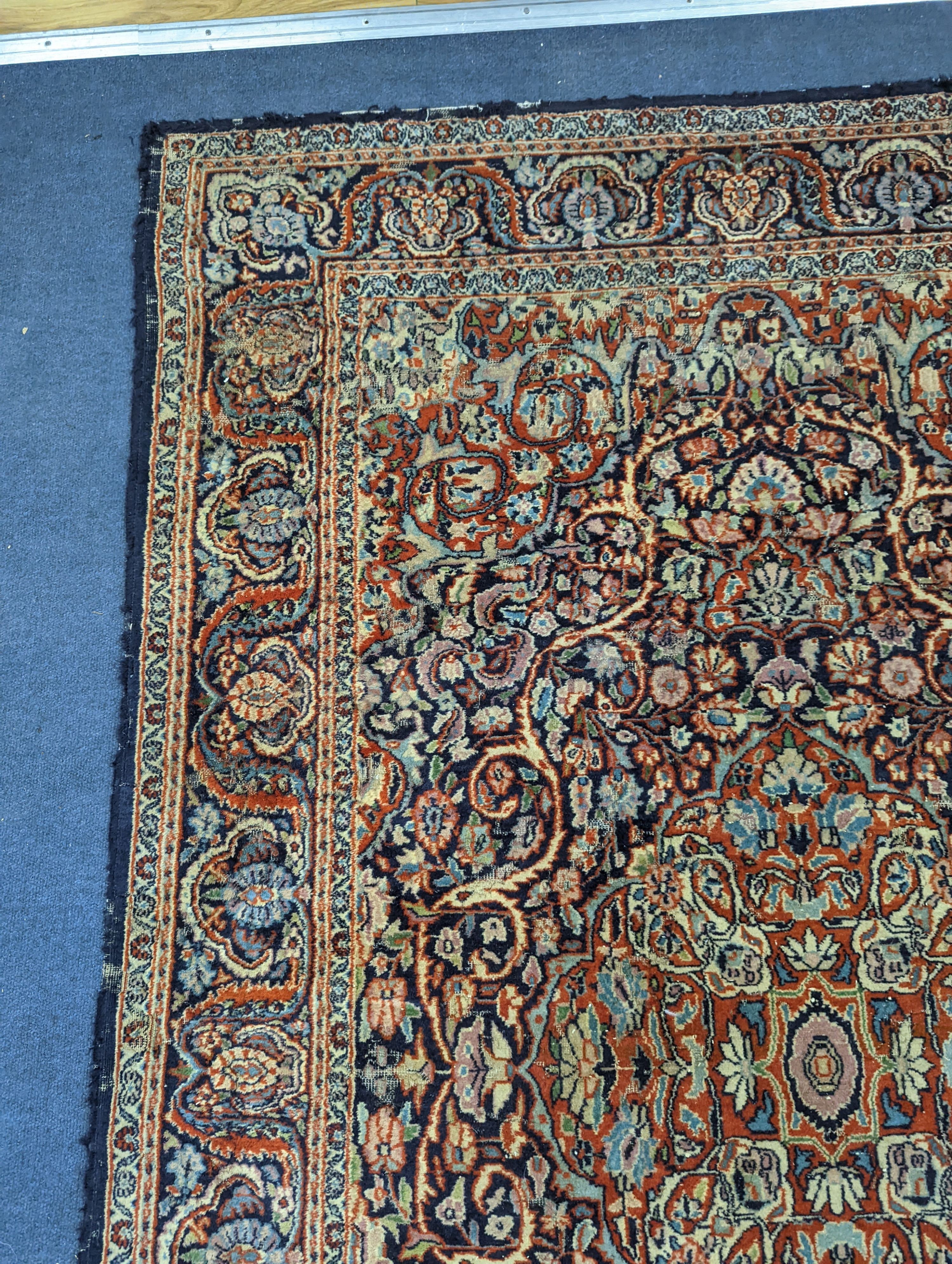 A Kashan blue ground rug, 185x122cm.